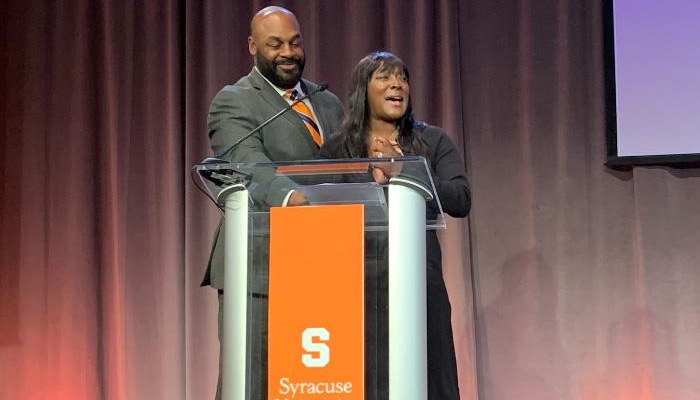 Roxi and Donovan McNabb on stage at Forever Orange Campaign Event